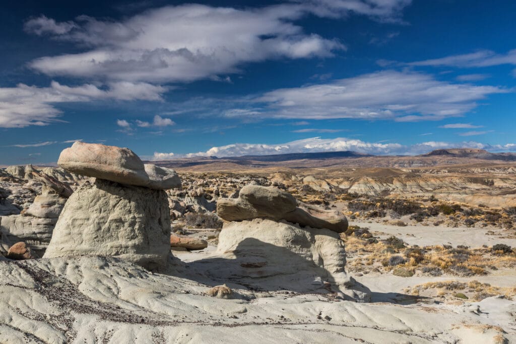 A dry desert landscape covered in boulders and wind worn stones.