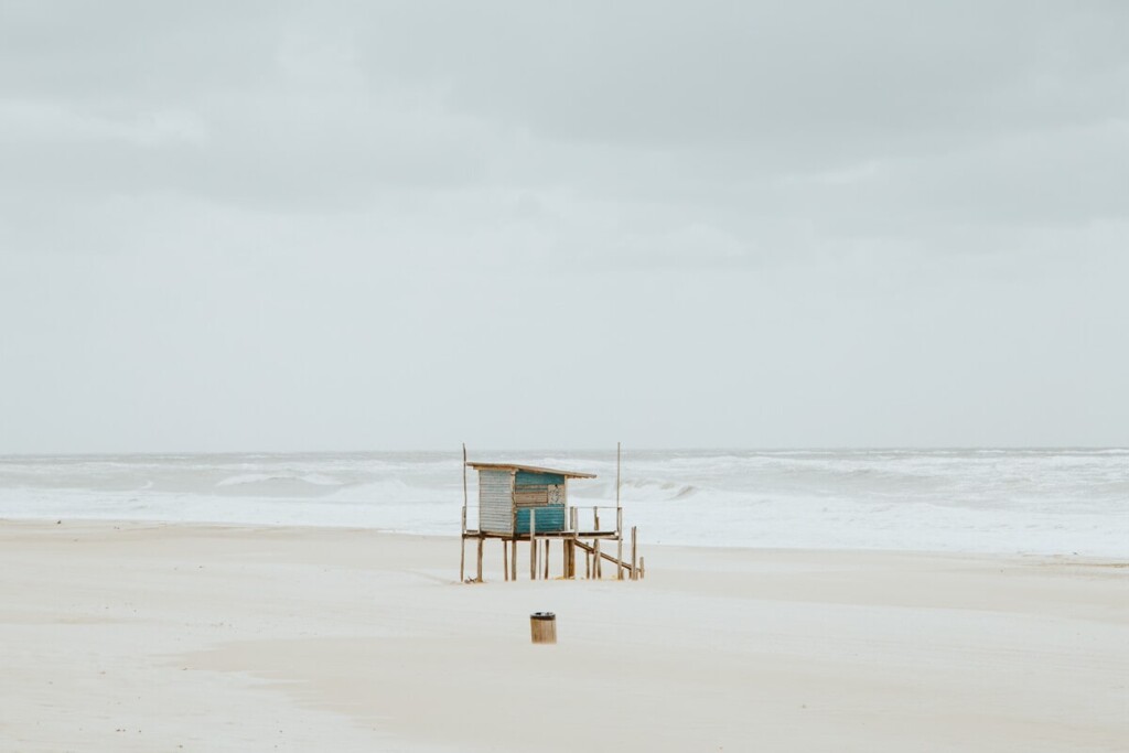 A blue lifeguard tower on a deserted beach
