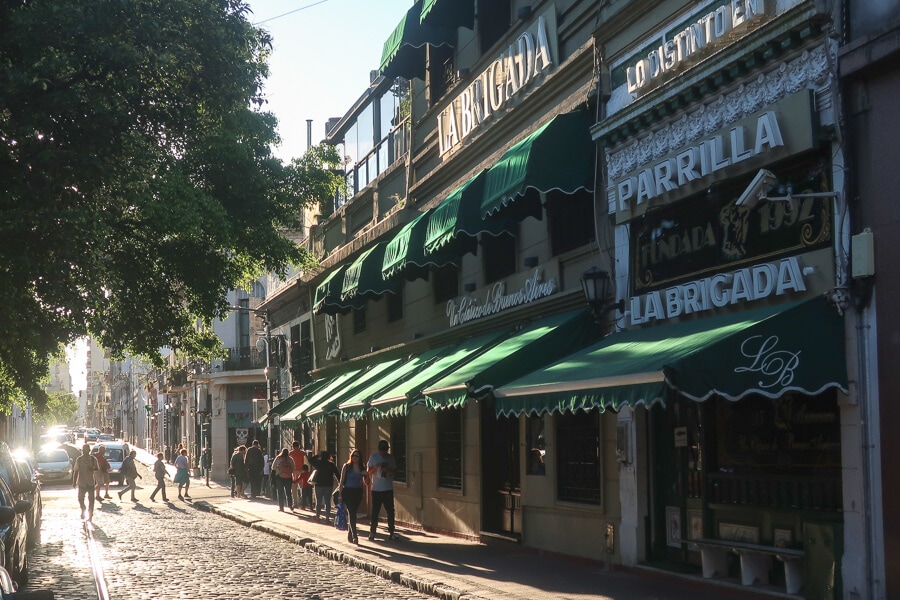 A cobblestone street in front of colonial buildings in San Telmo Argentina