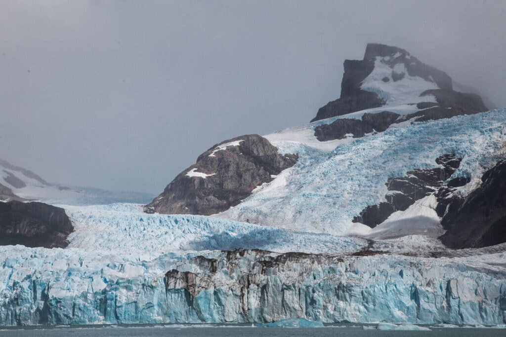 A bright turquoise glacier blankets a mountain in Patagonia