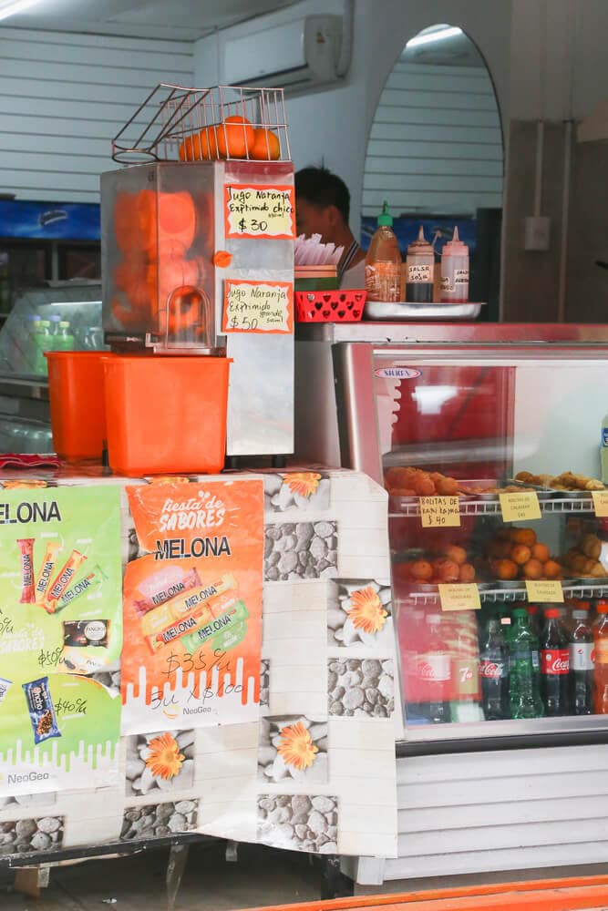 Oranges and a juicing machine on a restaurant counter