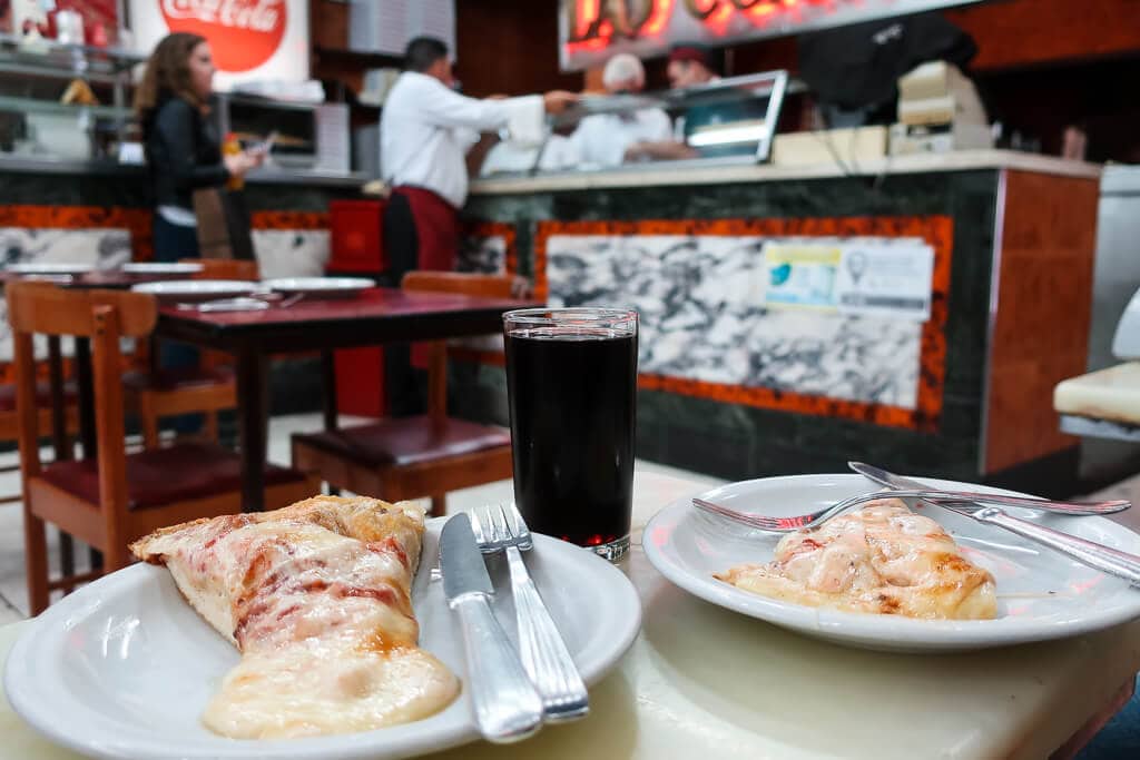 Two plates with cheese pizza on a table