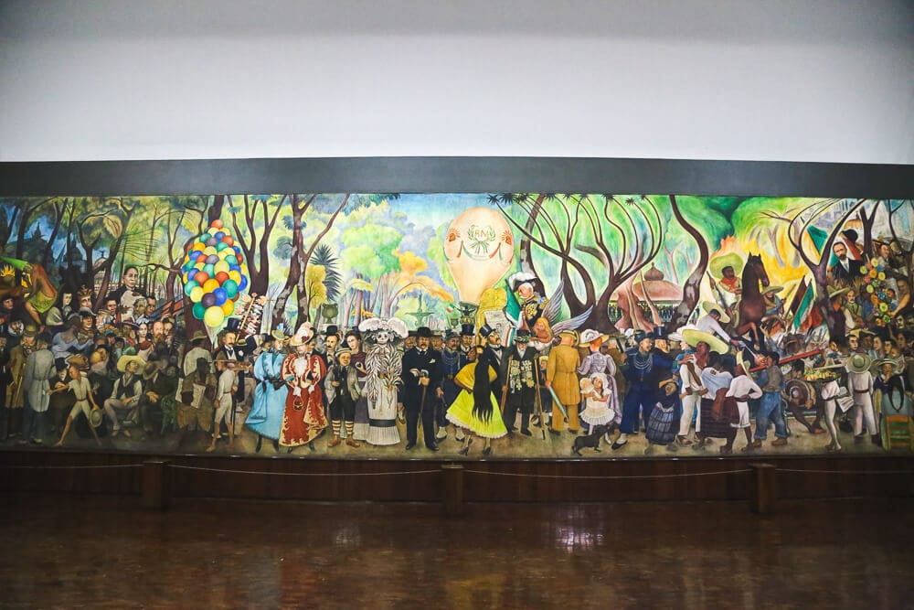 A large mural of Mexican life in a museum