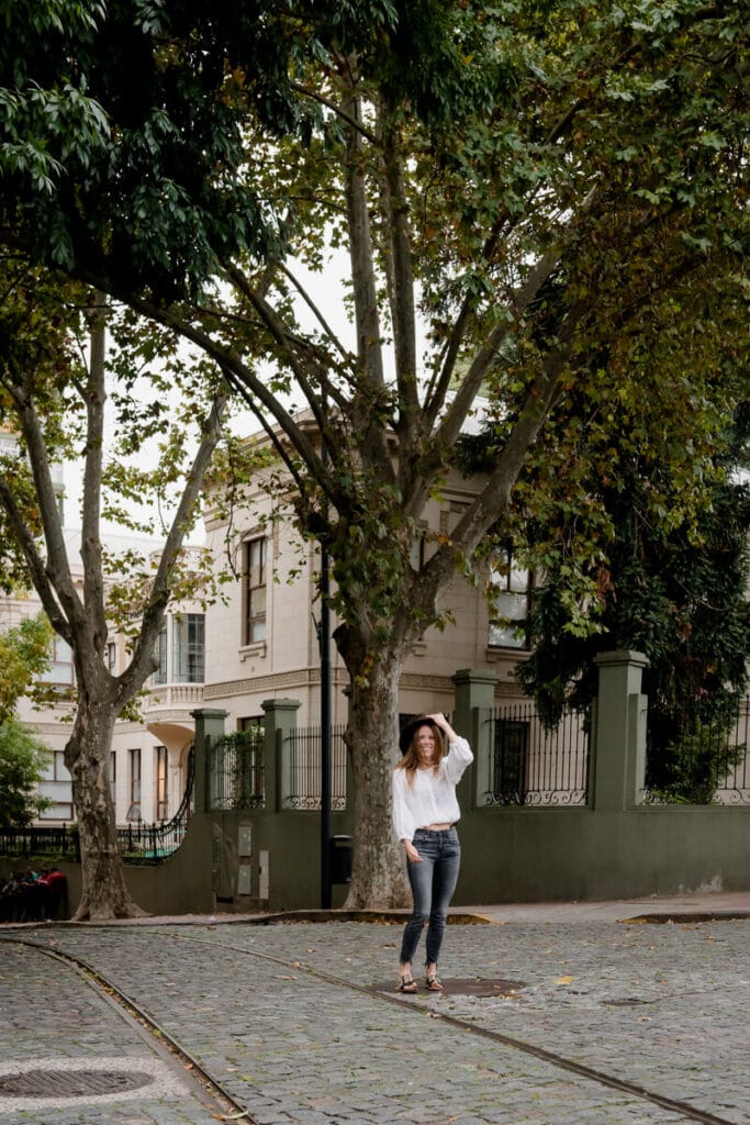 A woman stands in the middle of an intersection