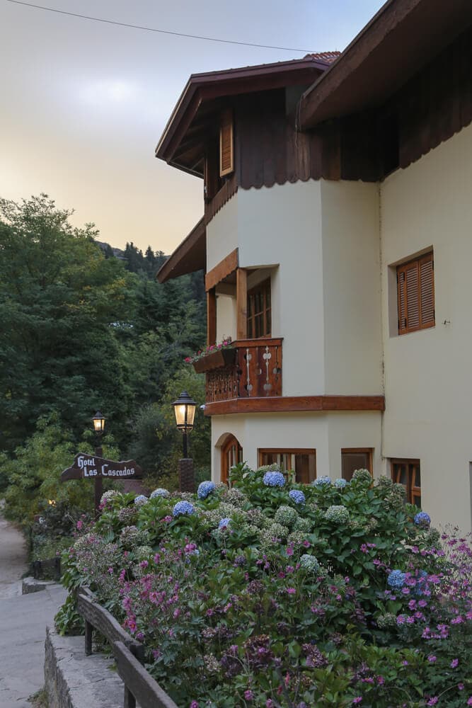 An alpine building behind hydrangea flowers