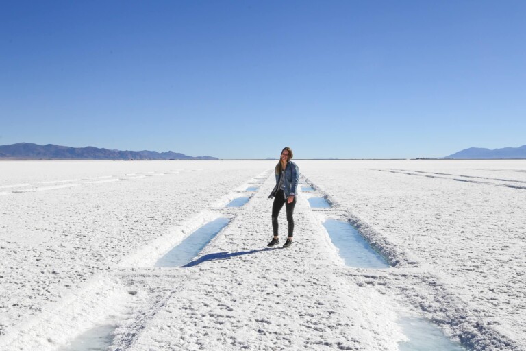 A woman walks between puddles of water on salt falts in Argentina