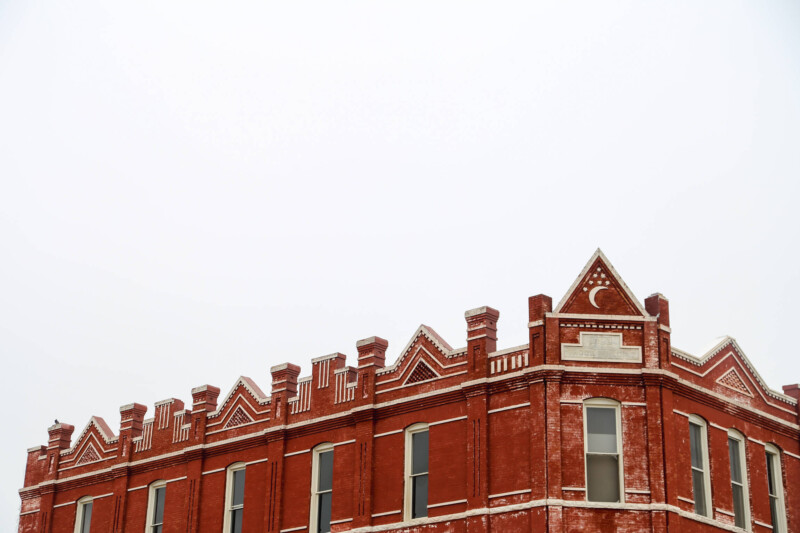 A red brick building and a white sky