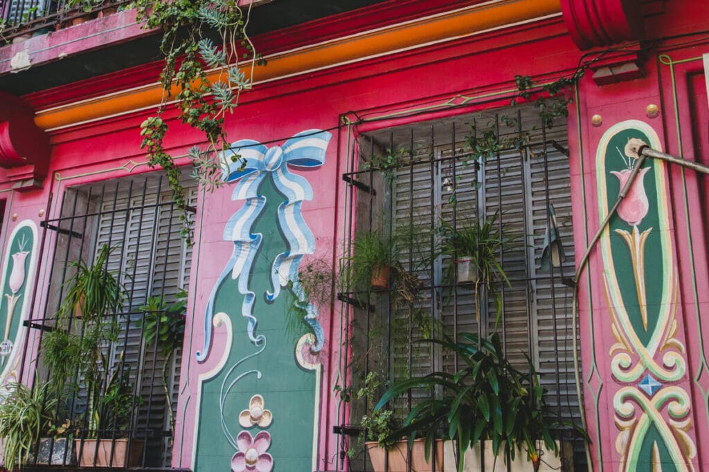 A red building facade painted in swirly designs