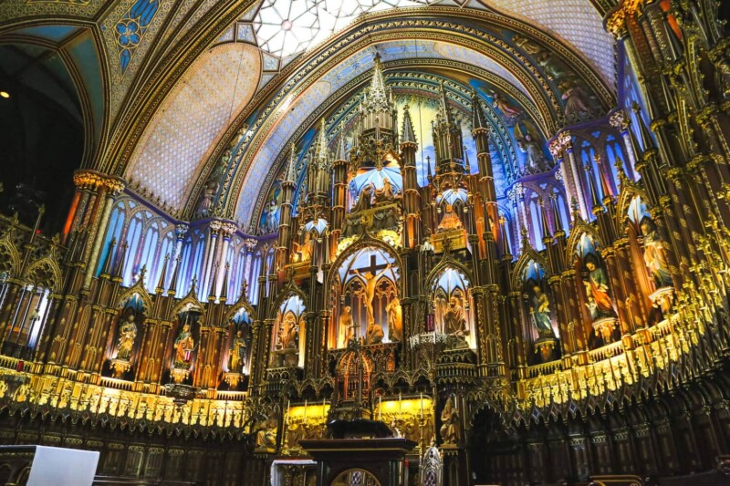 A golden alter and blue arches in Montreal Basilica