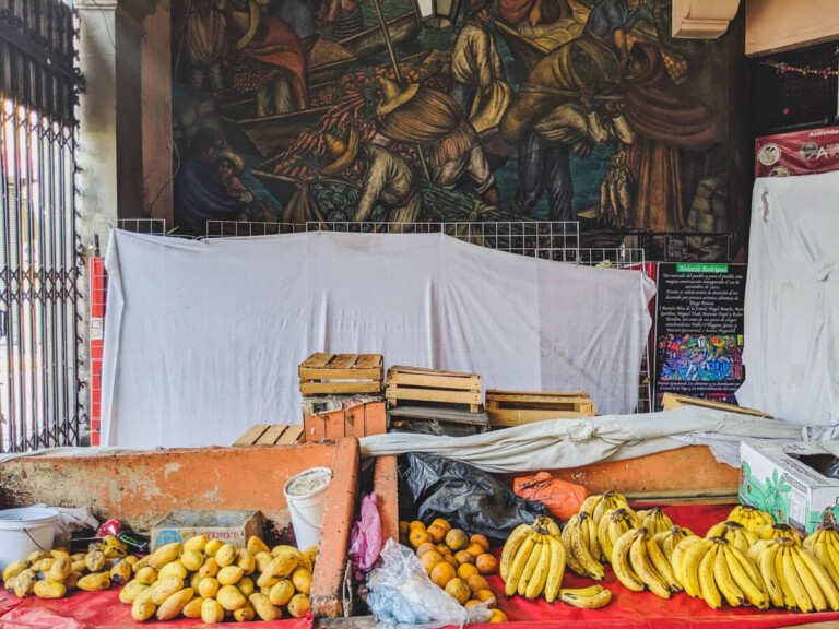 Bananas and mangos on red tablecloths in a Mexico City market