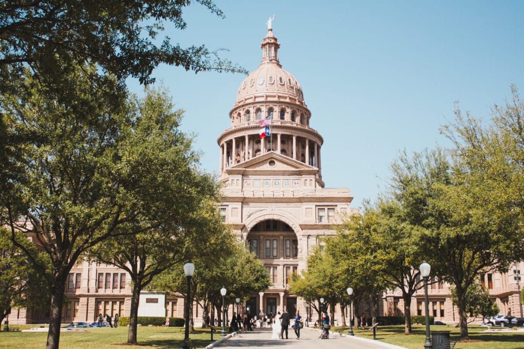 A government capitol building with a statue on the top of the dome