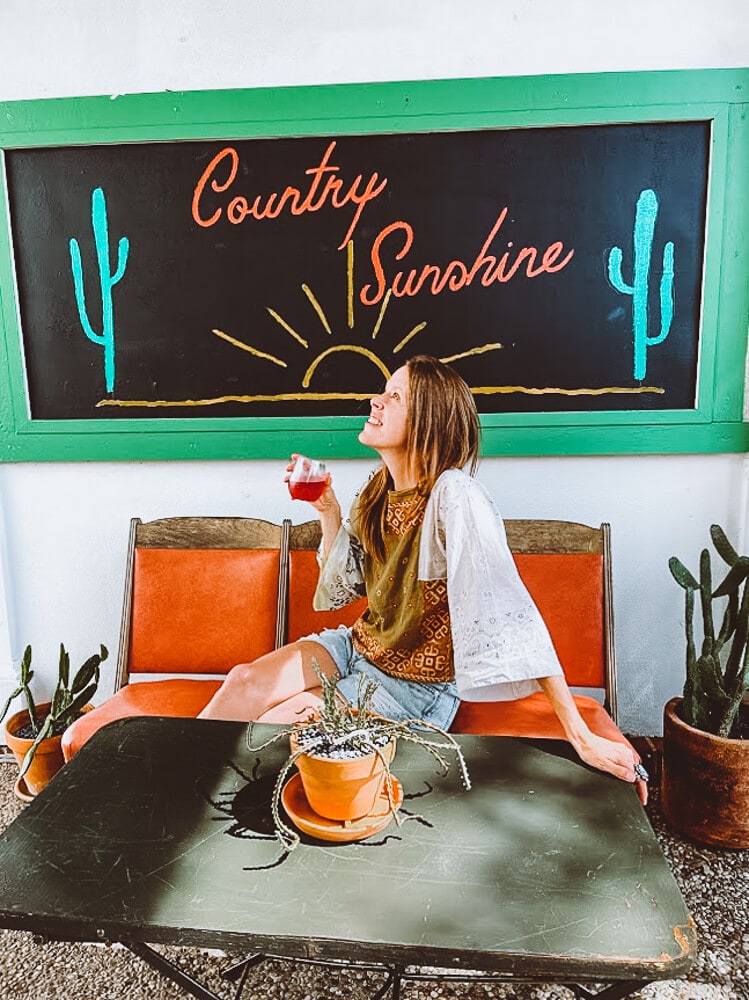 A woman drinks a glass of wine