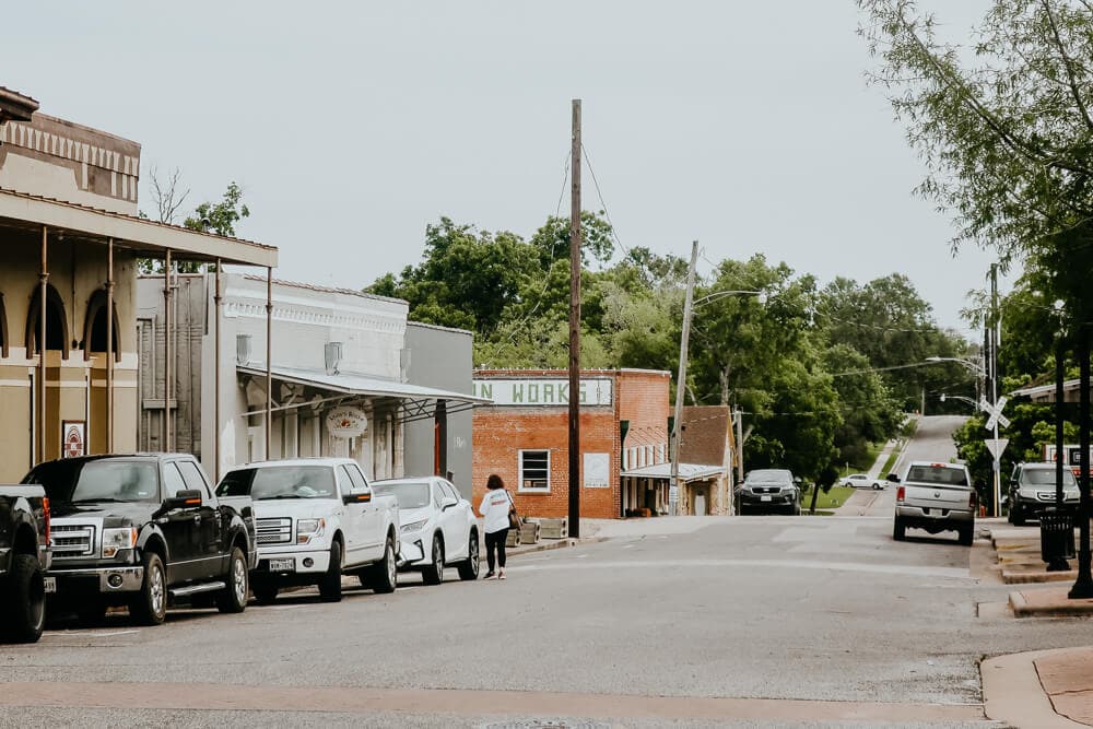 Trucks parked on the side of a road in a small town