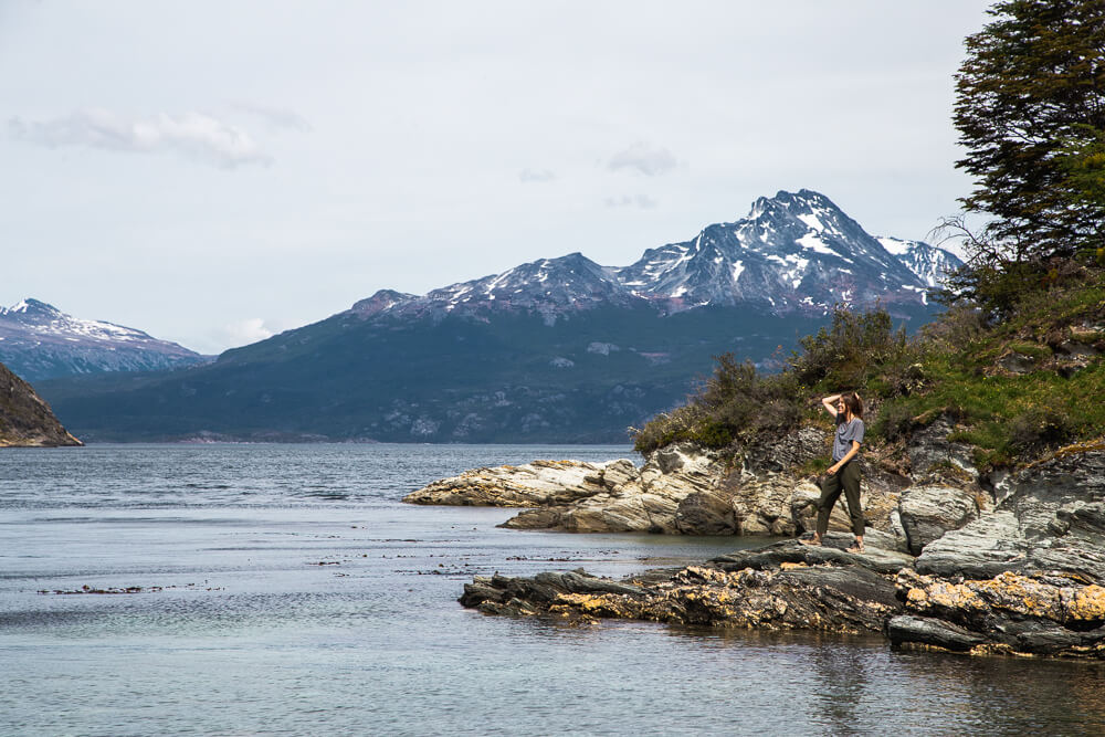 A woman on a rocky outcrop on a lake