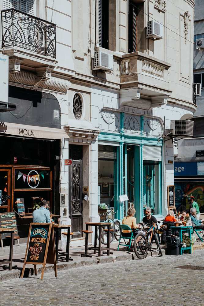 Sidewalk cafes in front of historic San Telmo buildings in a Buenos Aires neighborhood