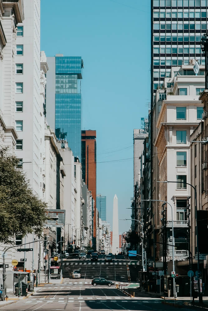 A multilane street leads to an obelisk