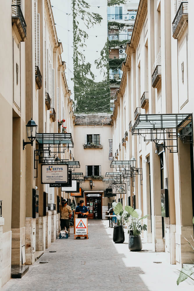 A passageway with signs leading to restaurants and stores