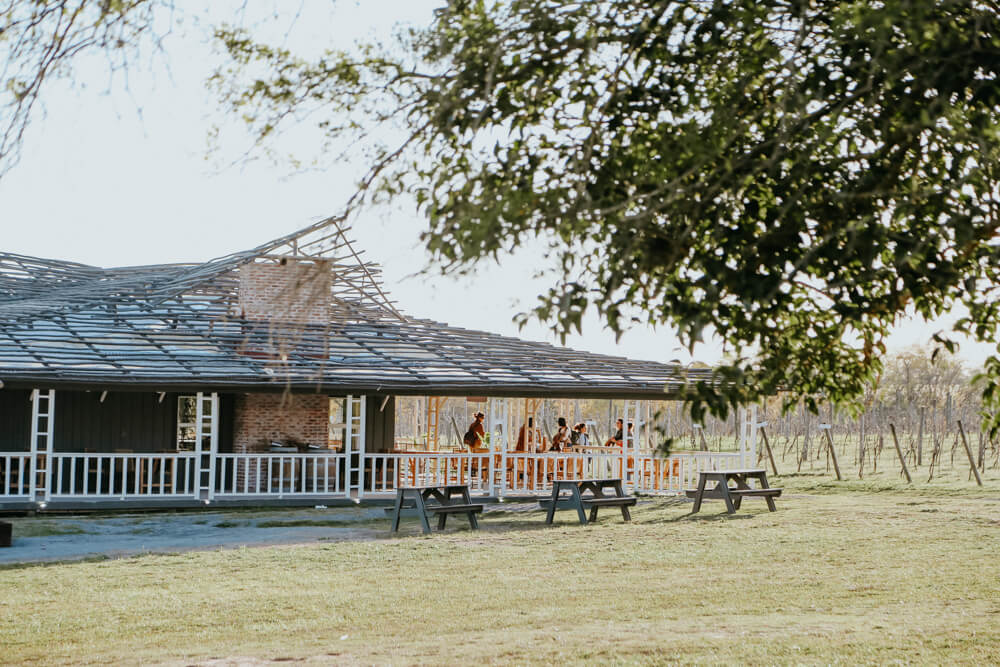 People stand on a porch at a restaurant in the countryside