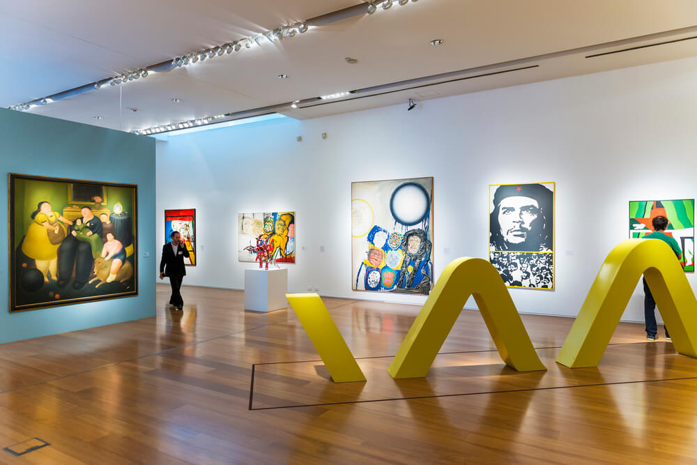 Paintings hang on a white wall in the MALBA museum in Buenos Aires