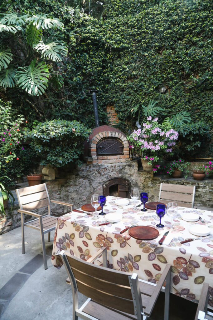 A table set for lunch in an ivy colored courtyard