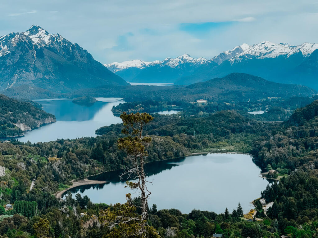 Lakes and forests at the food of snow capped mountains seen from Cerro Campanario, a Bariloche attraction