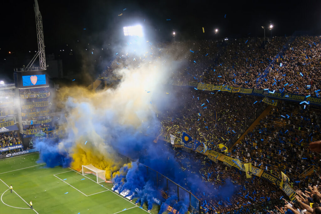 Blue and yellow smoke fills the stadium at a Boca Juniors football game in Buenos Aires